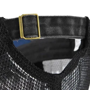 Detail of adjustable metal slider buckle and breathable mesh on black baseball cap