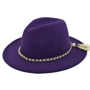 Detail view of purple wool fedora hat with gold chain, white pearls and beige tassels