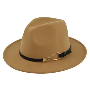 Detail of camel wool fedora hat featuring a black leather band and gold metal buckle