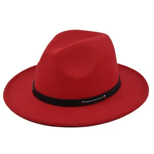 Detail view of red wool fedora hat with black leather band and silver metal studs