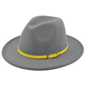 Detailed view of the yellow leather belt buckle on a classic grey felt fedora hat