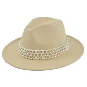 Detail of elegant beige felt fedora hat featuring a four-row pearl bead decoration band