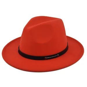 Detailed macro view of red wool fedora hat featuring a black faux leather studded band