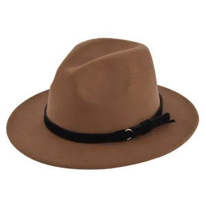Close-up of brown wool fedora hat featuring a black belt with gold ring and tassel detail