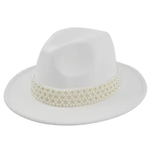 Detailed view of elegant white wool felt fedora featuring multi-layer pearl embellishment