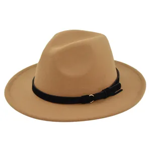 Macro detail of camel wool felt fedora featuring a black ribbon and gold buckle accent