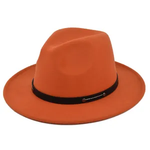 Detail of orange wool felt fedora hat featuring black leather band and metal buckle