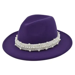 Détail du chapeau fedora violet foncé avec bande décorative de perles blanches multicouches