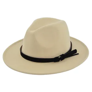 Detailed close-up of beige fedora hat with black suede belt and gold ring accent