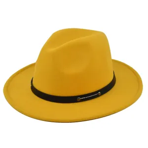 Detailed close-up of a yellow wool fedora hat with black leather band and silver studs