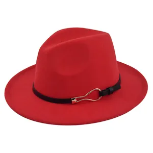 Macro shot of red felt fedora hat featuring a black leather belt with gold metal buckle