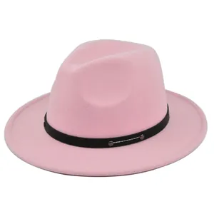 Detail of pink fedora wool hat featuring a black leather band and metal rivets decoration