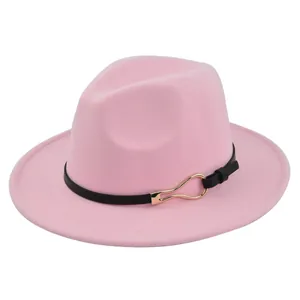 Close-up of pink wool fedora hat featuring a black leather band and gold metal buckle
