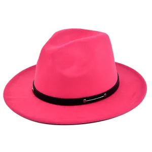 Detail of bright pink fedora hat featuring black band with silver metal studs
