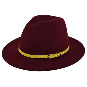 Detail of burgundy wool fedora featuring a bright yellow leather belt with gold buckle