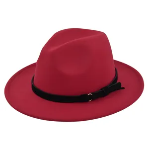Close-up of red fedora hat with black suede belt and decorative gold metal ring buckle