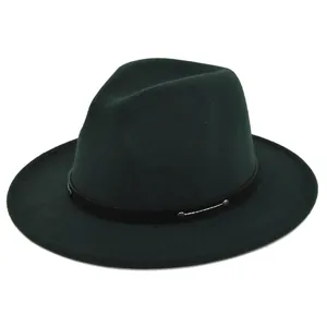 Detail of dark green fedora hat featuring black band and metallic silver studs