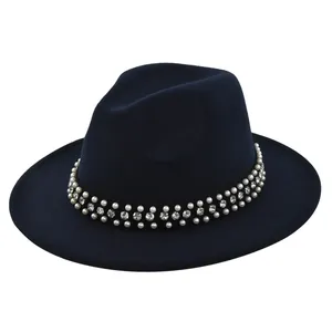 Detail of navy wool fedora hat featuring a decorative band with pearls and rhinestones