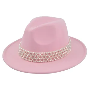 Detailed view of pink wool fedora hat featuring elegant white pearl band embellishment