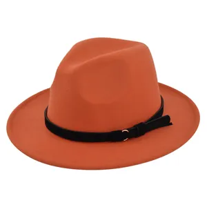 Close-up of orange wool fedora hat with black belt band and golden buckle detail
