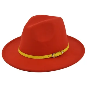 Detail of red wool fedora hat featuring a contrast yellow belt with silver buckle