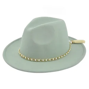 Detail of sage green wool fedora hat with gold chain, pearls and ivory tassel charm