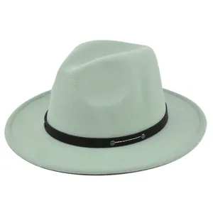 Detail of mint green wool fedora hat with black studded band and wide brim design