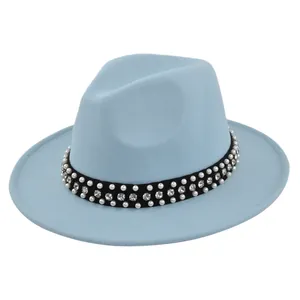 Detail of light blue wool felt fedora featuring black band with pearls and crystals