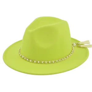 Detail of neon yellow wool fedora hat featuring gold chain with white pearl tassels