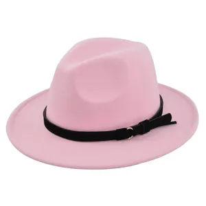 Detail of pink fedora wool hat featuring a black belt with gold metal ring and fringe