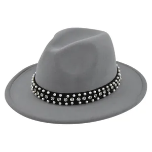 Top view of a dark grey wool fedora featuring a black velvet band with pearls and rhinestones