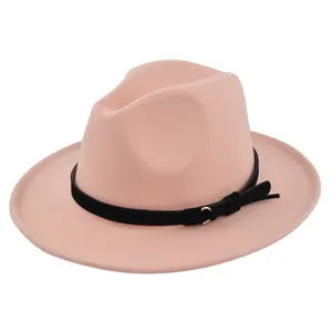 Detail of pink fedora hat with black band, gold metal ring buckle and bow decoration