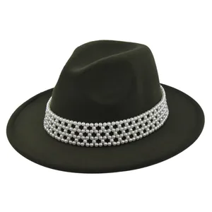 Detail view of a dark green wool fedora hat featuring a premium white pearl beaded band