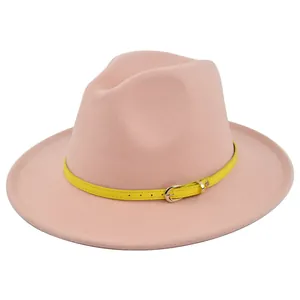 Detail of pink wool fedora hat featuring yellow leather belt strap and gold buckle