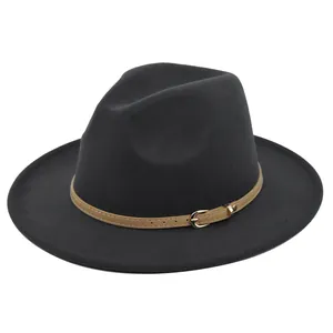 Macro-detail van zwarte vilten fedora hoed met bruine lederen riem en gouden gesp erop