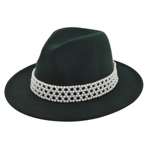 Detail of dark green wool fedora hat featuring an elegant white pearl beaded band