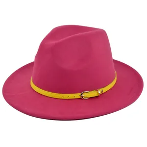 Detail of pink wool fedora hat featuring a bright yellow belt with a silver buckle