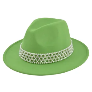 Detail of green wool fedora hat featuring an elegant multi-layer white pearl hatband