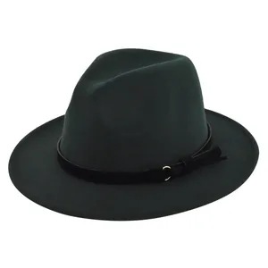 Detail of dark green fedora featuring a black leather band with golden ring and tassel