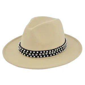 Detail of beige fedora hat with elegant velvet band featuring pearls and rhinestones