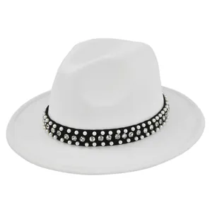 Detail of white wool fedora hat featuring black band with pearls and rhinestones