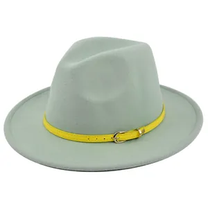 Detail of mint green wool fedora hat featuring a bright yellow leather belt with metal buckle