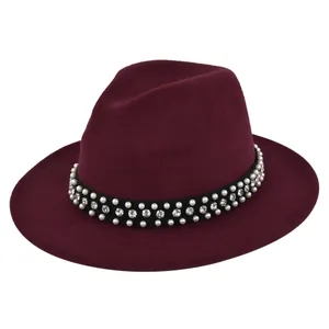 Close-up of burgundy fedora hat with elegant pearl and rhinestone embellished band