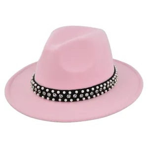 Detailed shot of pink wool fedora hat with elegant pearl and rhinestone hatband trim