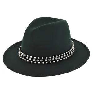 Detail of dark green fedora hat featuring black band with rows of pearls and rhinestones