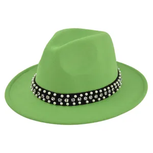 Detail of green wool fedora hat featuring black ribbon band with pearls and rhinestones
