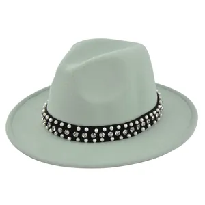 Close-up of light green wool fedora hat featuring pearl and rhinestone studded band detail