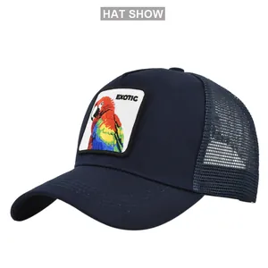 Close-up of the exotic parrot embroidery patch on a navy blue mesh trucker baseball cap