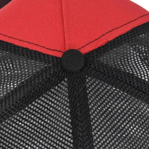 Close-up of red twill and black mesh stitching on a six-panel trucker baseball cap