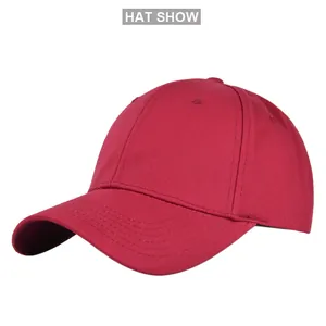 Detail of magenta cotton baseball cap showing woven texture and reinforced stitching